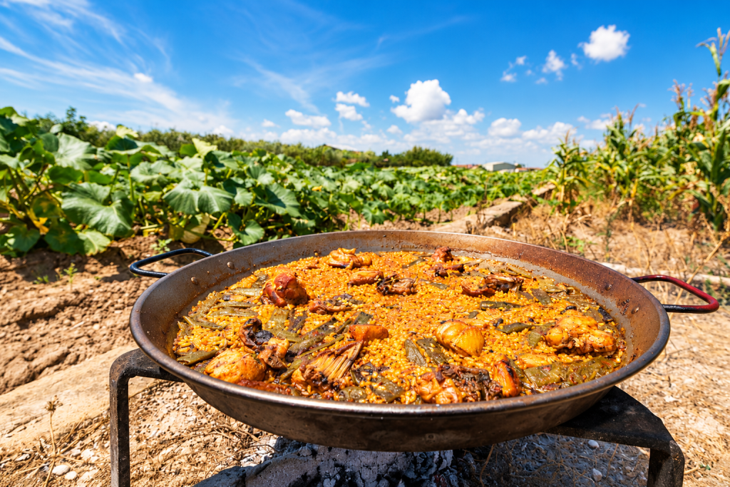 Traditional Paella Valenciana cooked outdoors in Valencia