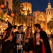 Halloween in Valencia with people in costumes near Valencia Cathedral at night
